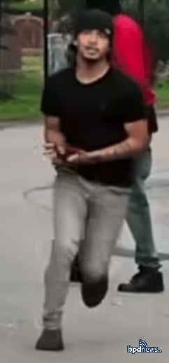 The same suspect running from the scene, with a second suspect in a red top visible behind him. Photo: Boston Police Department.