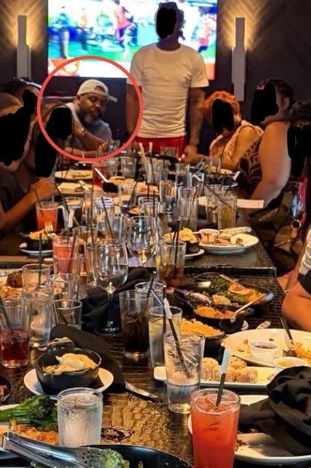 LaMar Cook seated at a communal STK Disney Springs table with a party of eight to ten diners.