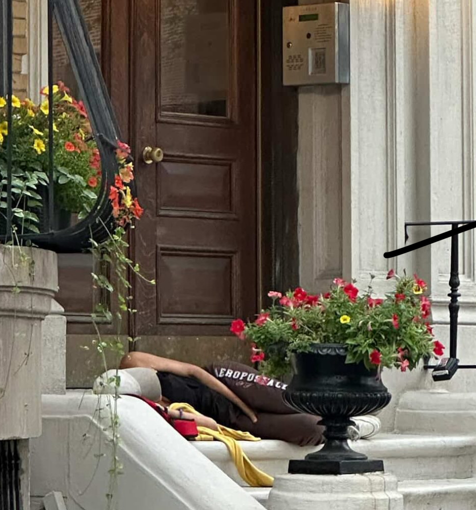 Slumped on a stoop: A person lies unconscious outside a Boston brownstone — as city leaders like Sharon Durkan block emergency action and insist the crisis is under control. / Instagram @southendsos