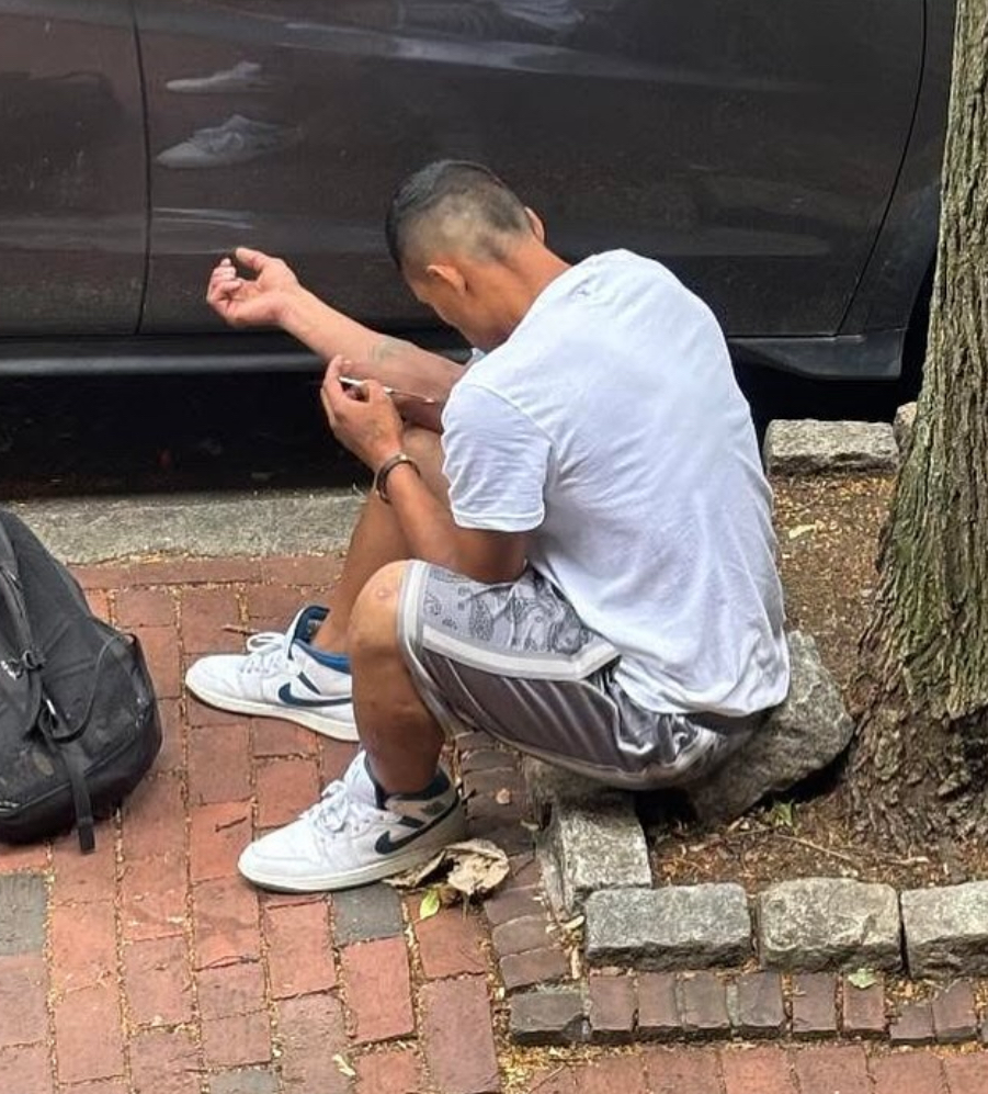 An addict shoots up just steps away from family homes. Photo credit: Instagram @southendsos