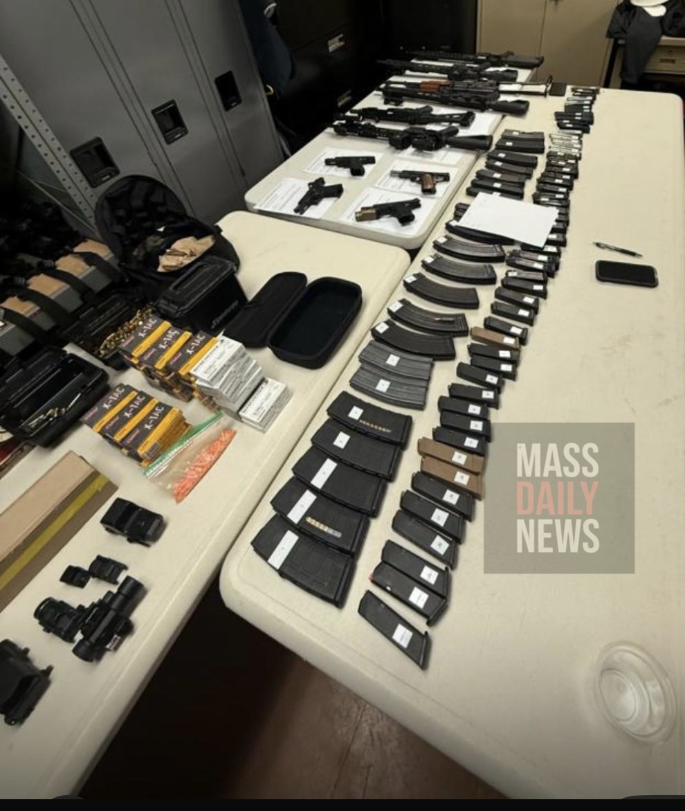 Weapons, magazines, and boxes of ammunition laid out on an evidence table after investigators raided the Milton home of Boston Fire Lt. Joshua Thompson.