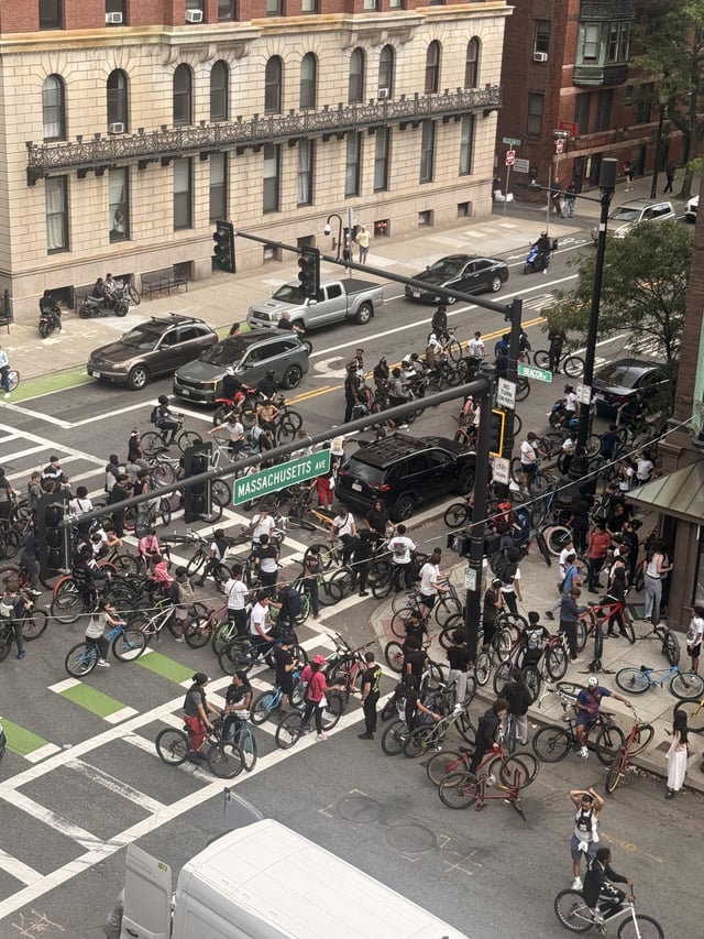 A swarm of more than a hundred hooded bicyclists seized Mass Ave, blocking intersections and turning Boston’s main drag into a wheelie-popping free-for-all as stunned drivers sat trapped in the chaos.