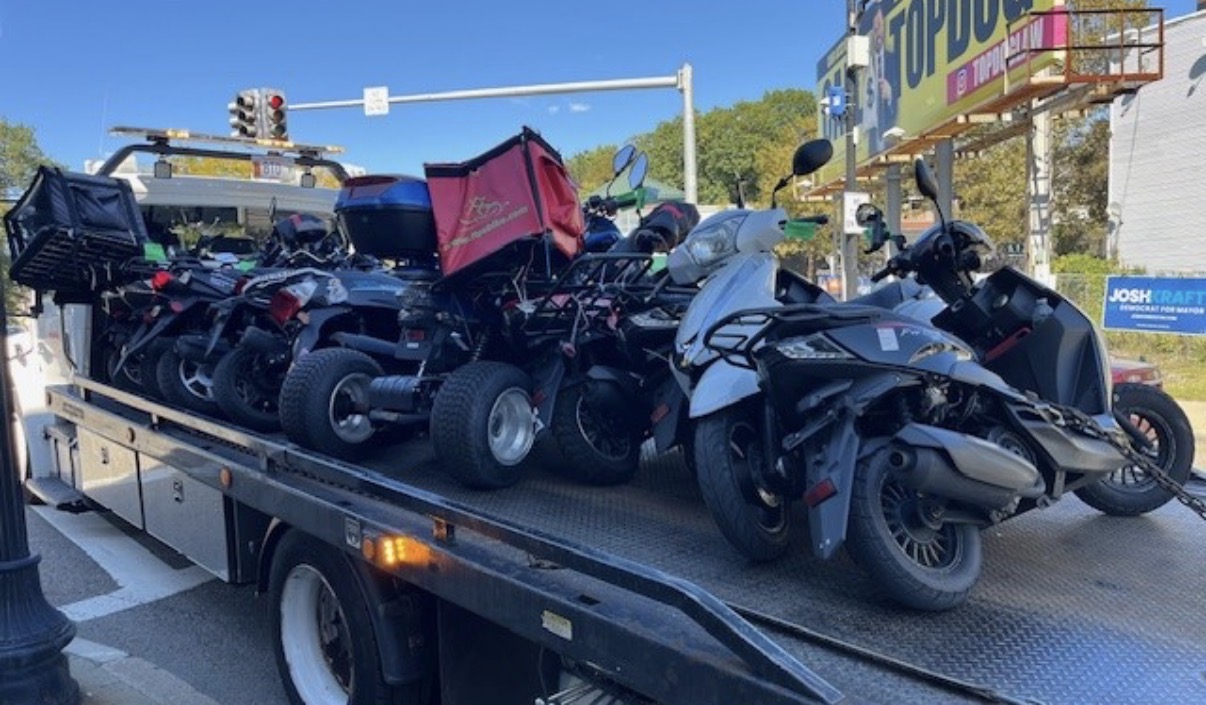 The prize haul: Boston cops lined up 12 scooters after the Dorchester sweep