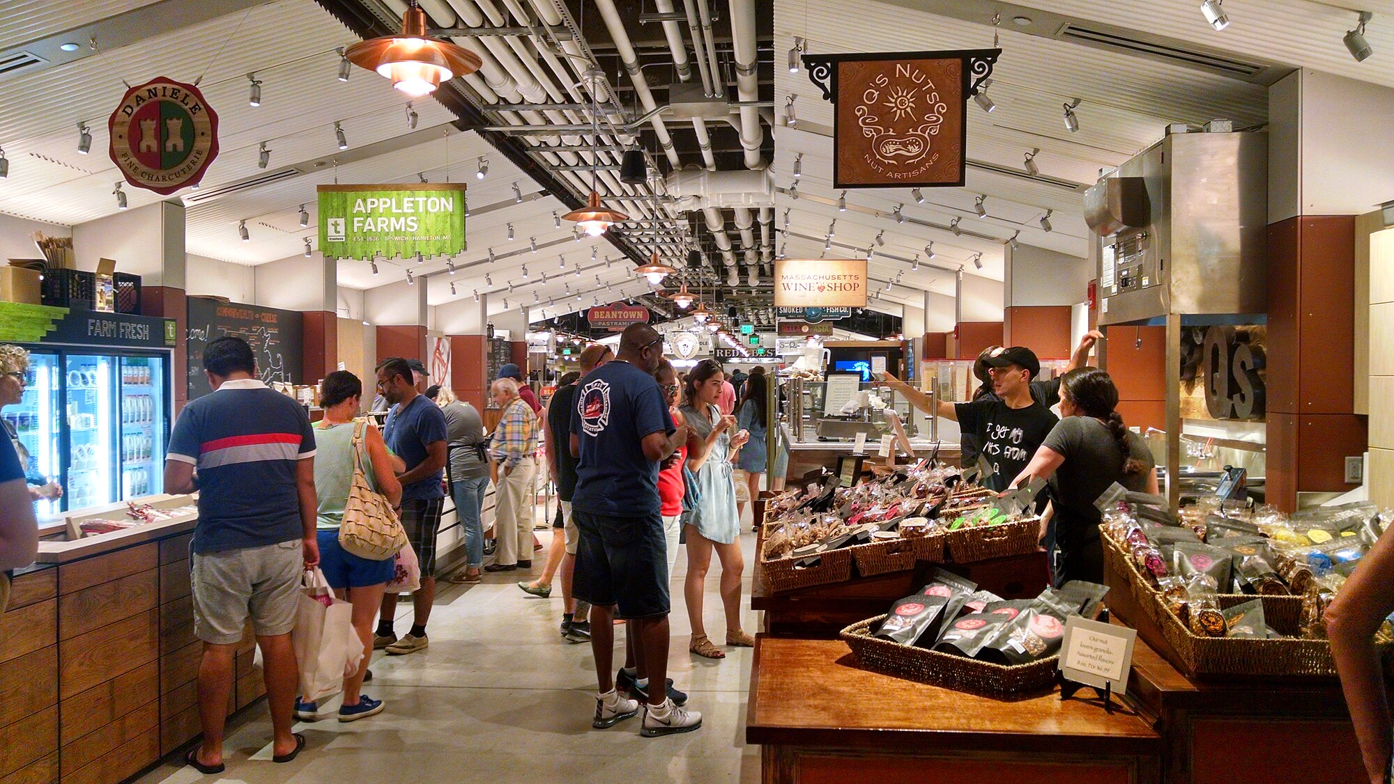 Shoppers browse local vendors inside the Boston Public Market, a taxpayer-subsidized food hall on the Rose Kennedy Greenway.