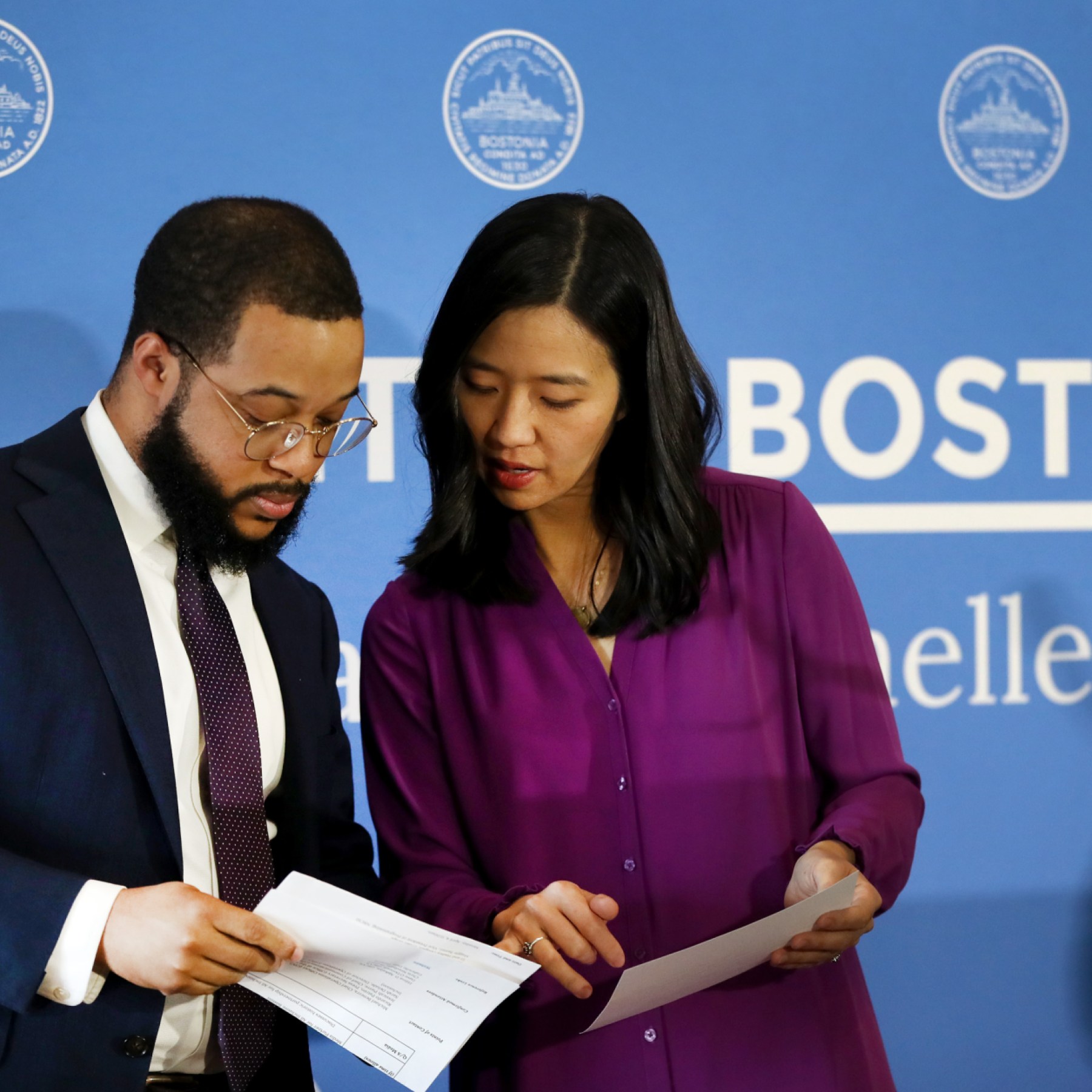 Mayor Michelle Wu reviews documents with Segun Idowu at City Hall. (Nancy Lane/Boston Herald)