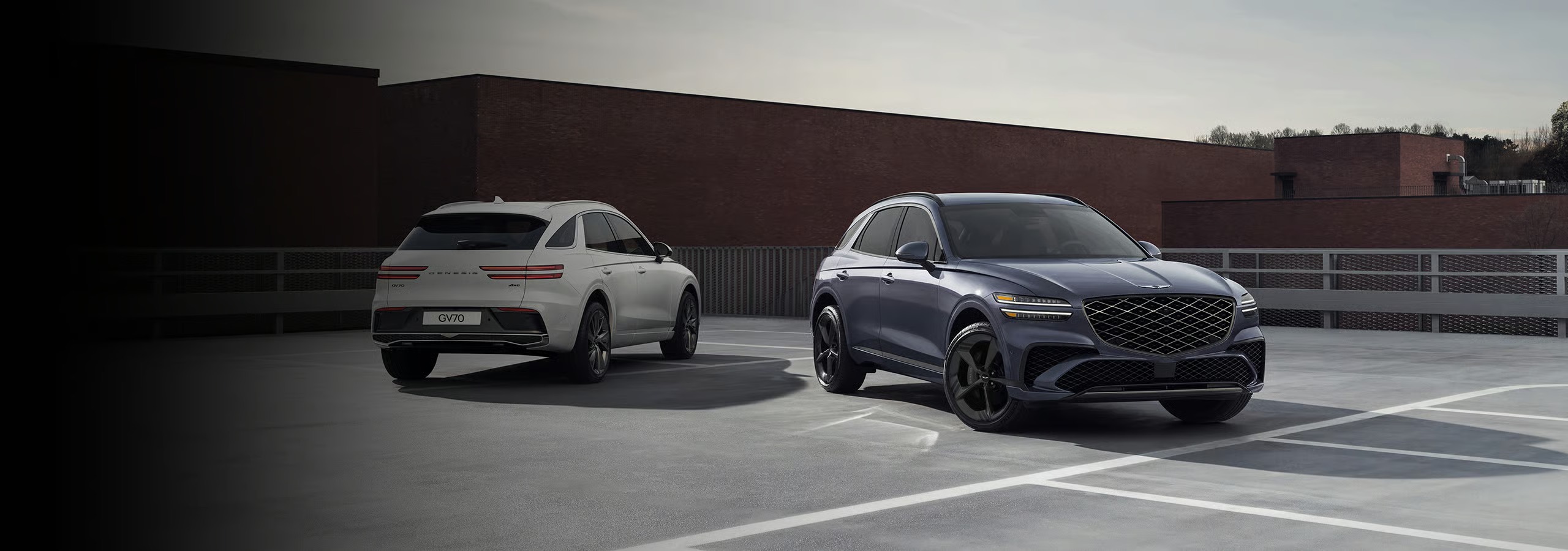 VUS Genesis GV80 et GV70 vus de trois quarts avant sur un stationnement urbain, véhicules de luxe offrant design raffiné et confort haut de gamme à prix compétitif.