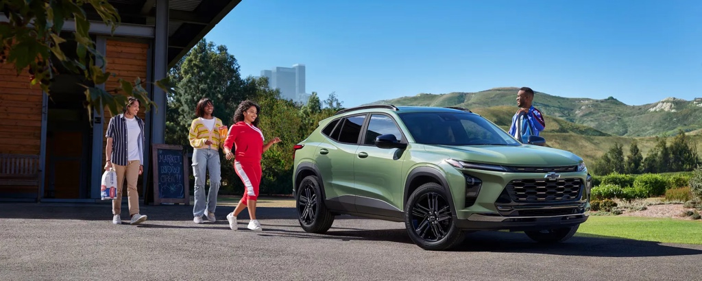 Chevrolet Trax vert avec des passants en ville pour illustrer un VUS citadin économique en carburant.