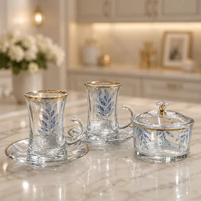 Gold-accented glass cup set with sugar bowl