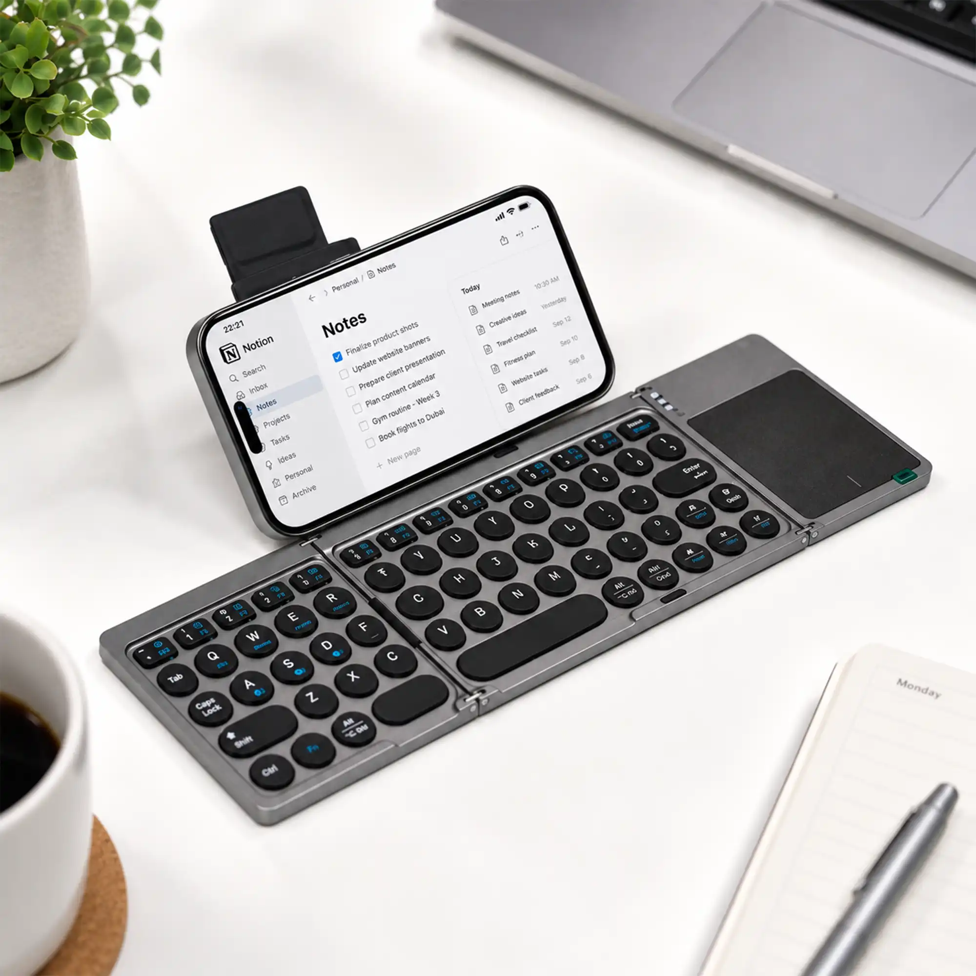 Foldable Bluetooth keyboard open flat showing the full layout and touchpad