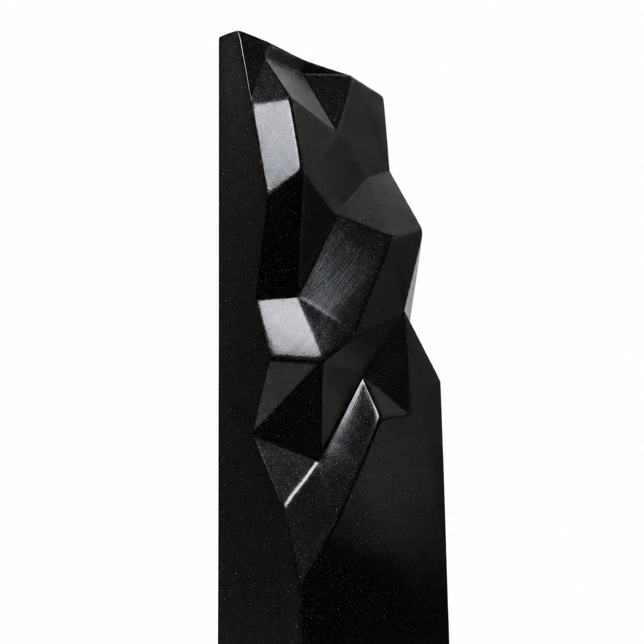 Black geometric faceted crystal award column on a desk