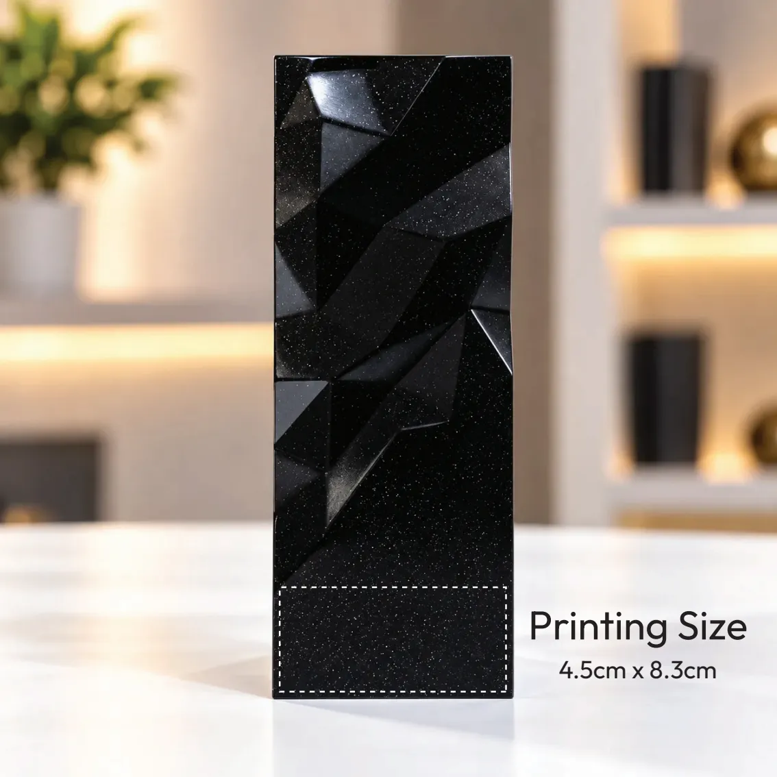 Black geometric faceted crystal award column on a desk