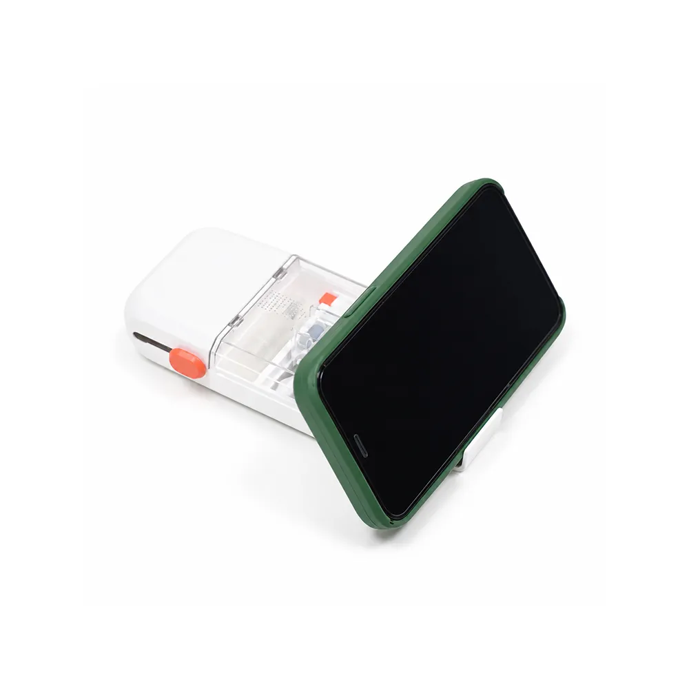 Green-cased phone held in landscape by the cleaning kit's fold-out phone holder