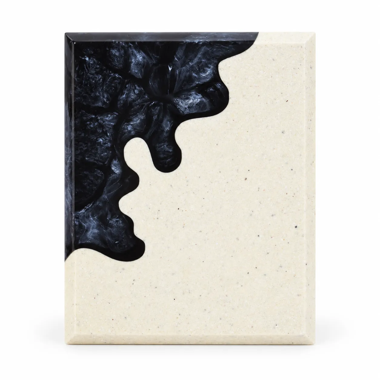 Black abstract crystal award with cream body on a desk