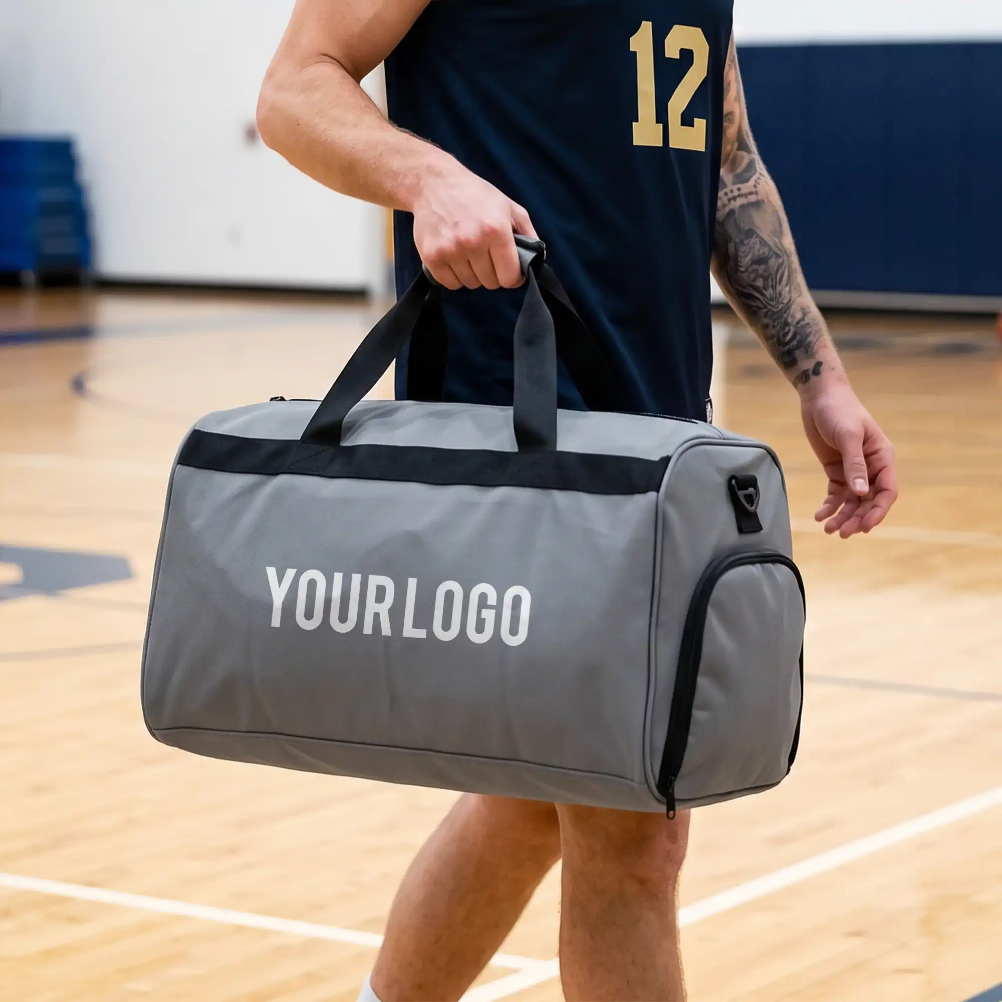 Modern gray duffle travel bag with dual handles and adjustable strap