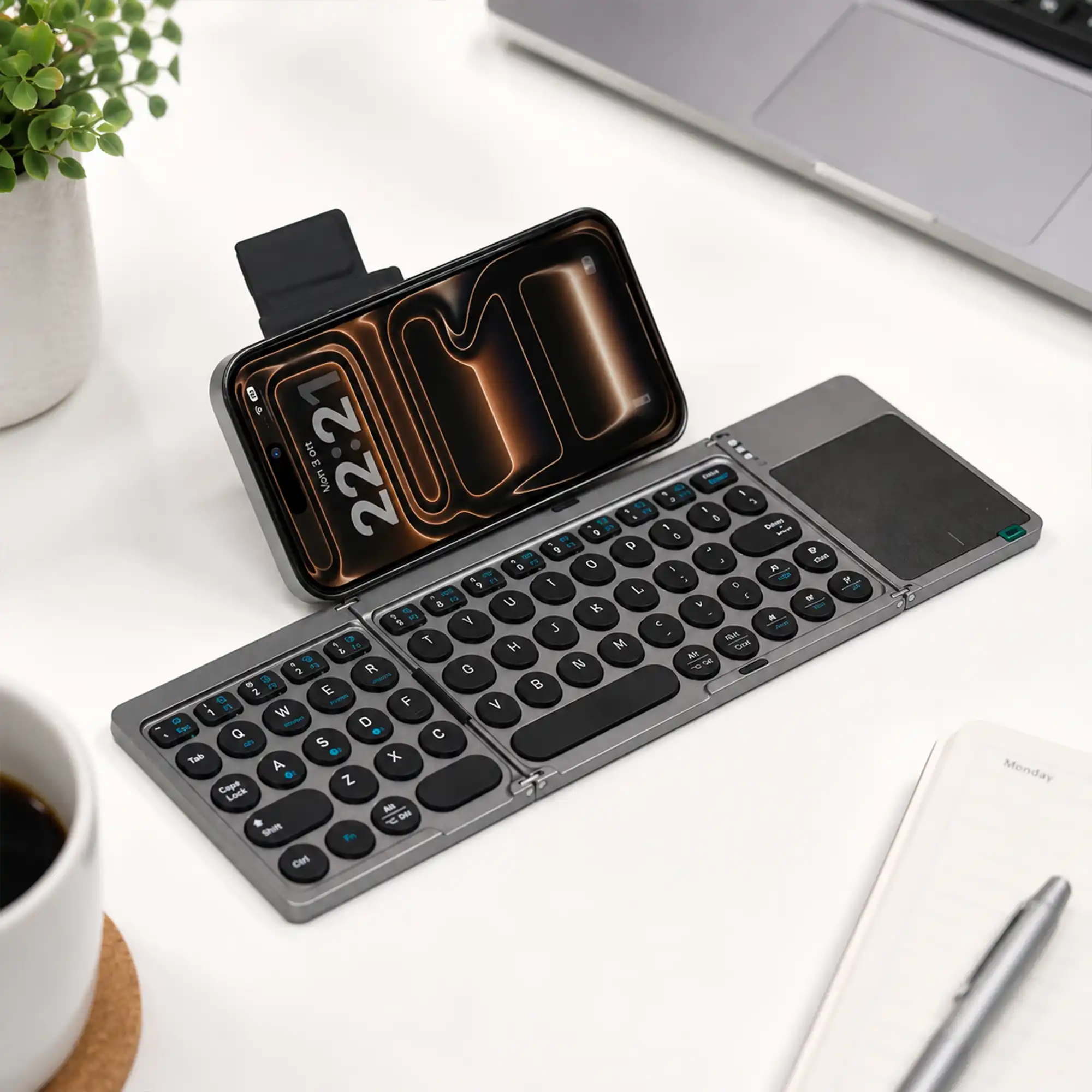 Foldable Bluetooth keyboard open flat showing the full layout and touchpad
