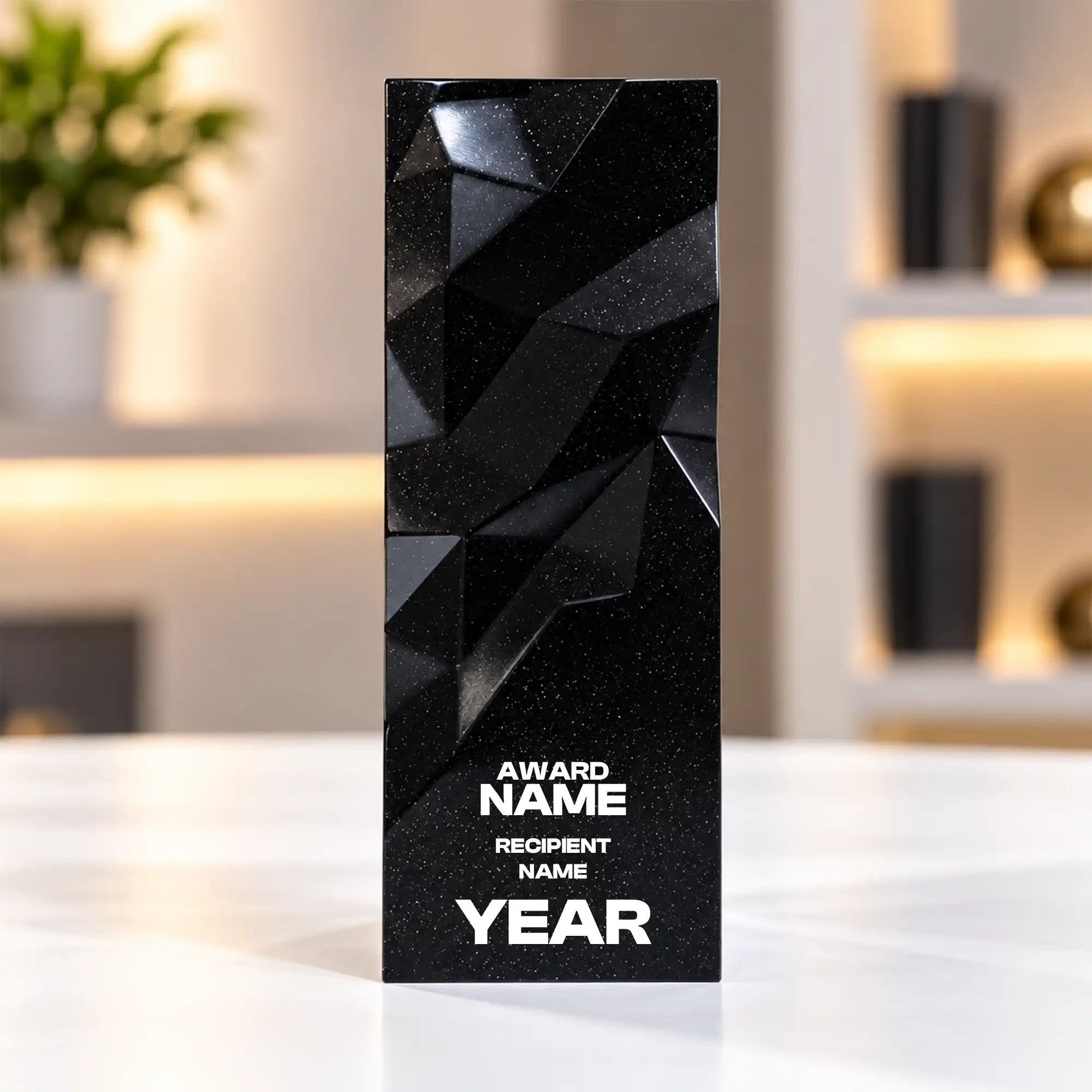 Black geometric faceted crystal award column on a desk