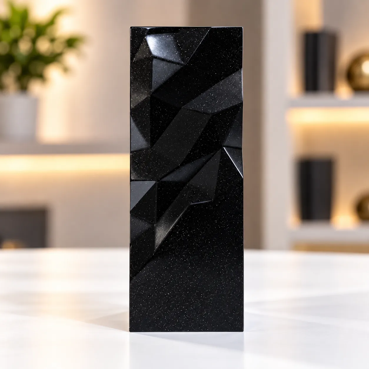 Black geometric faceted crystal award column on a desk