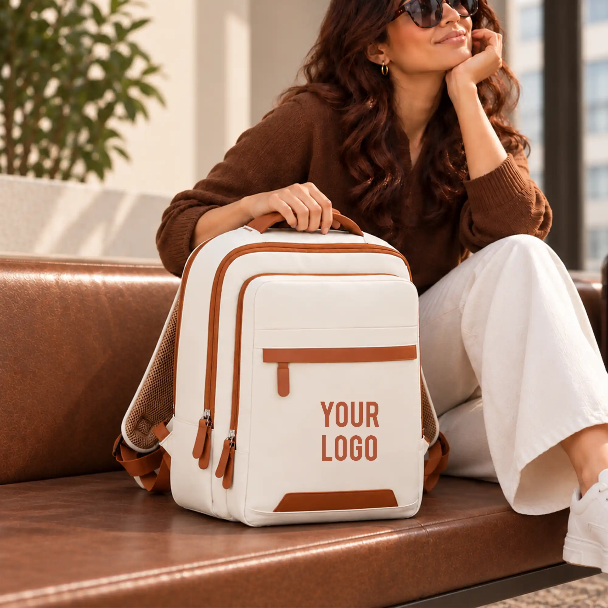 Beige Voxtra travel backpack, front three-quarter view with tan leather trim