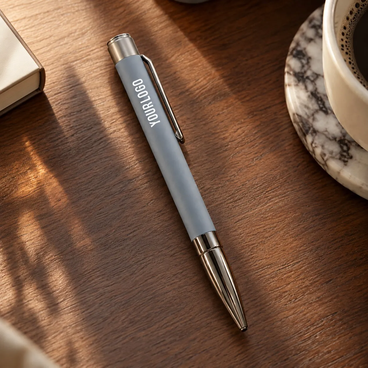 Grey matte metal ballpoint pen with gunmetal clip and bullet tip on white