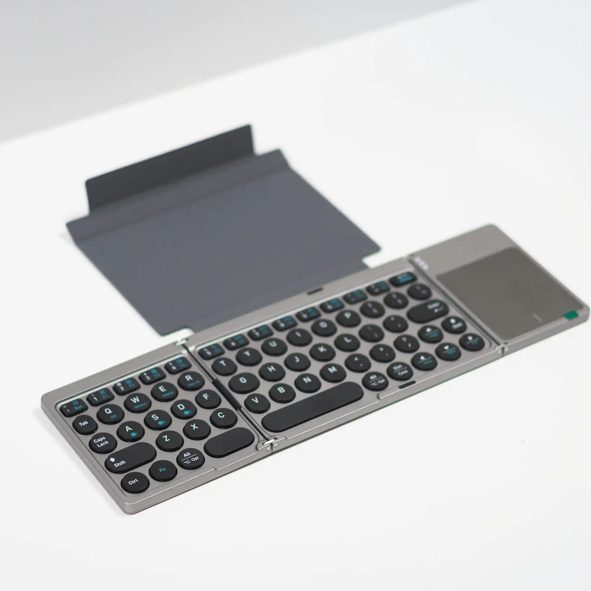 Foldable Bluetooth keyboard open flat showing the full layout and touchpad