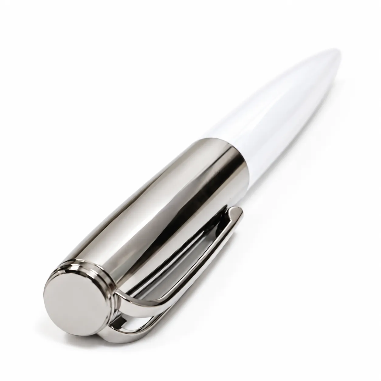 White glossy metal ballpoint pen with long polished metal top standing upright