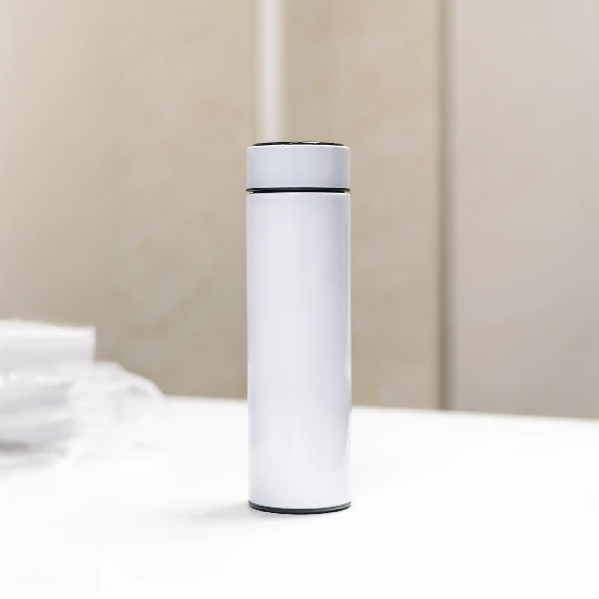 Minimal white stainless-steel smart bottle standing on table