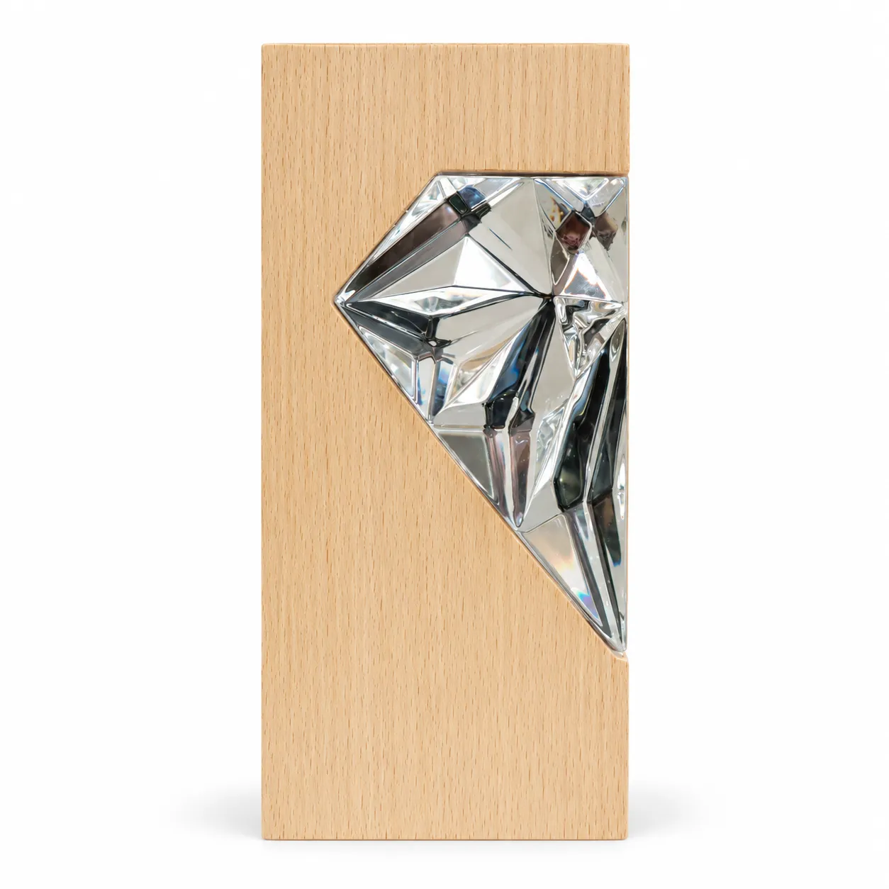 Silver crystal diamond award on wood base, close-up of faceted surface