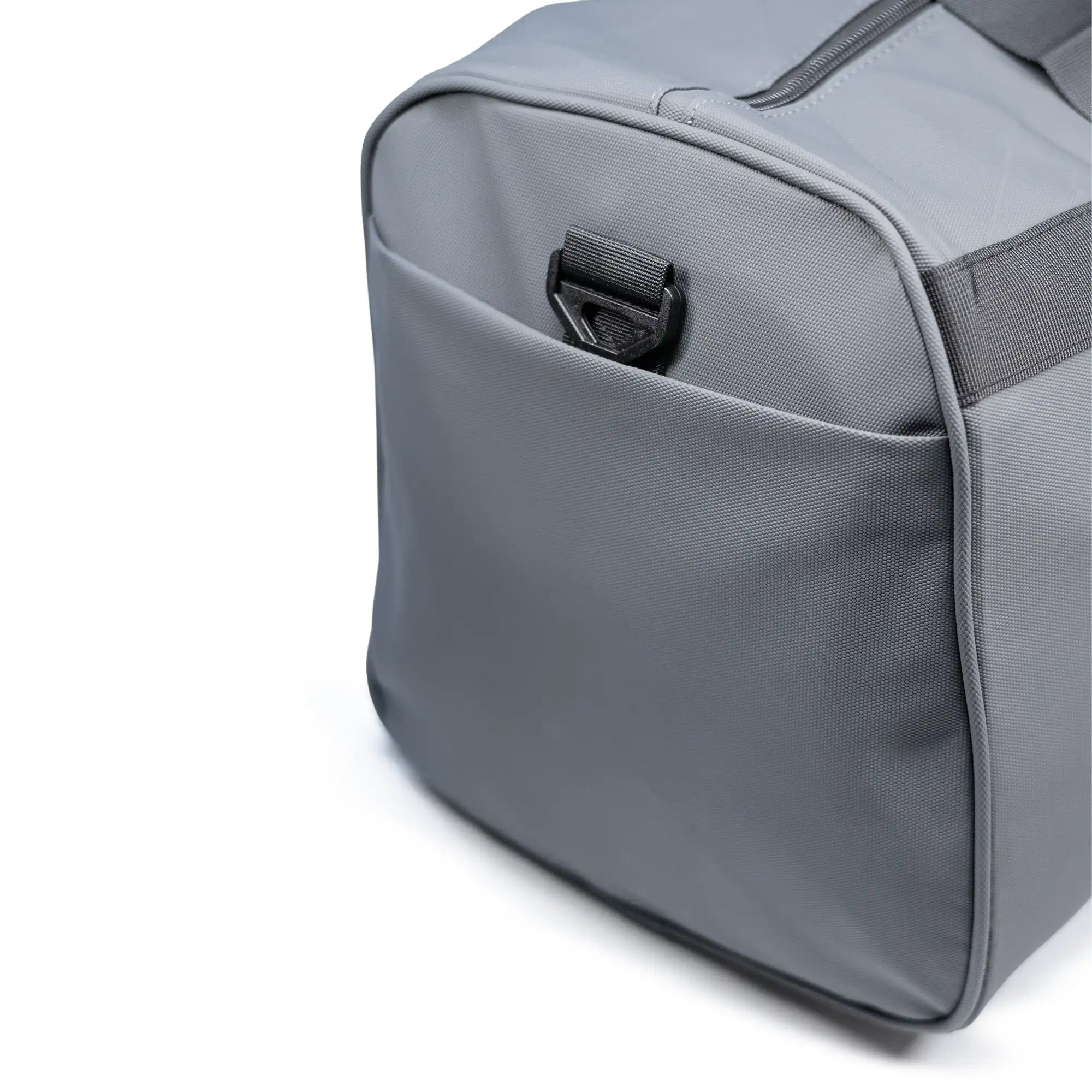 Modern gray duffle travel bag with dual handles and adjustable strap