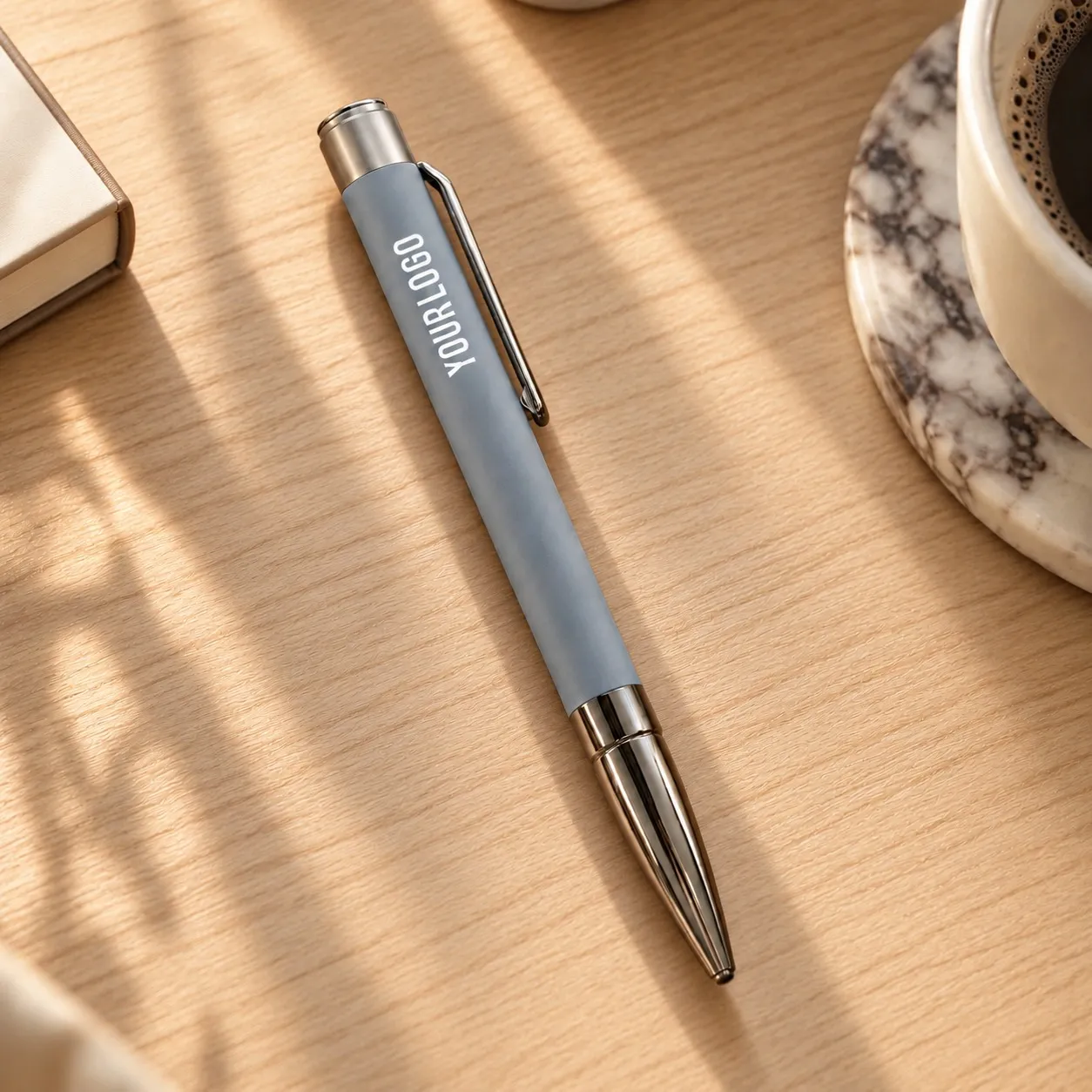 Grey matte metal ballpoint pen with gunmetal clip and bullet tip on white