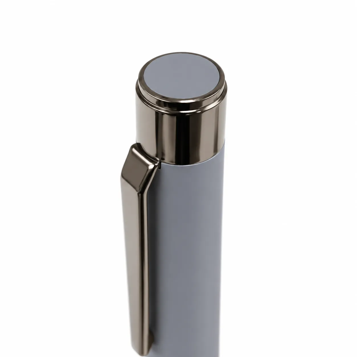Grey matte metal ballpoint pen with gunmetal clip and bullet tip on white