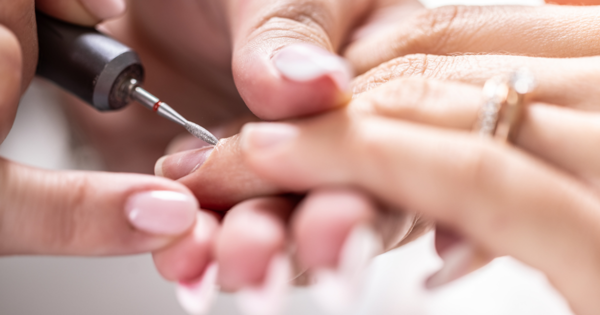 nail technician performing gentle cuticle care to protect the natural skin barrier