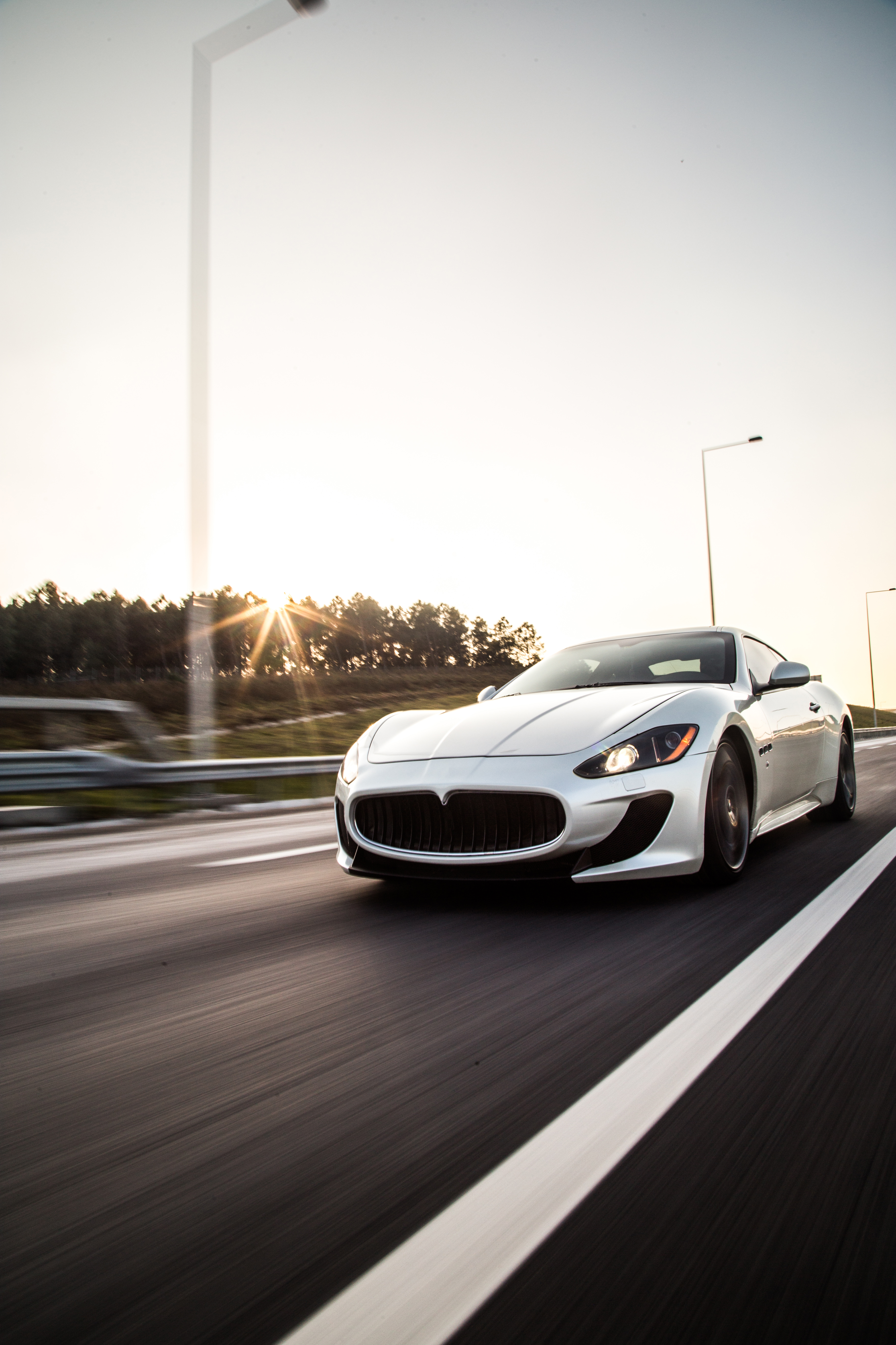 Sliver metallic color sport car driving with high speed on the road