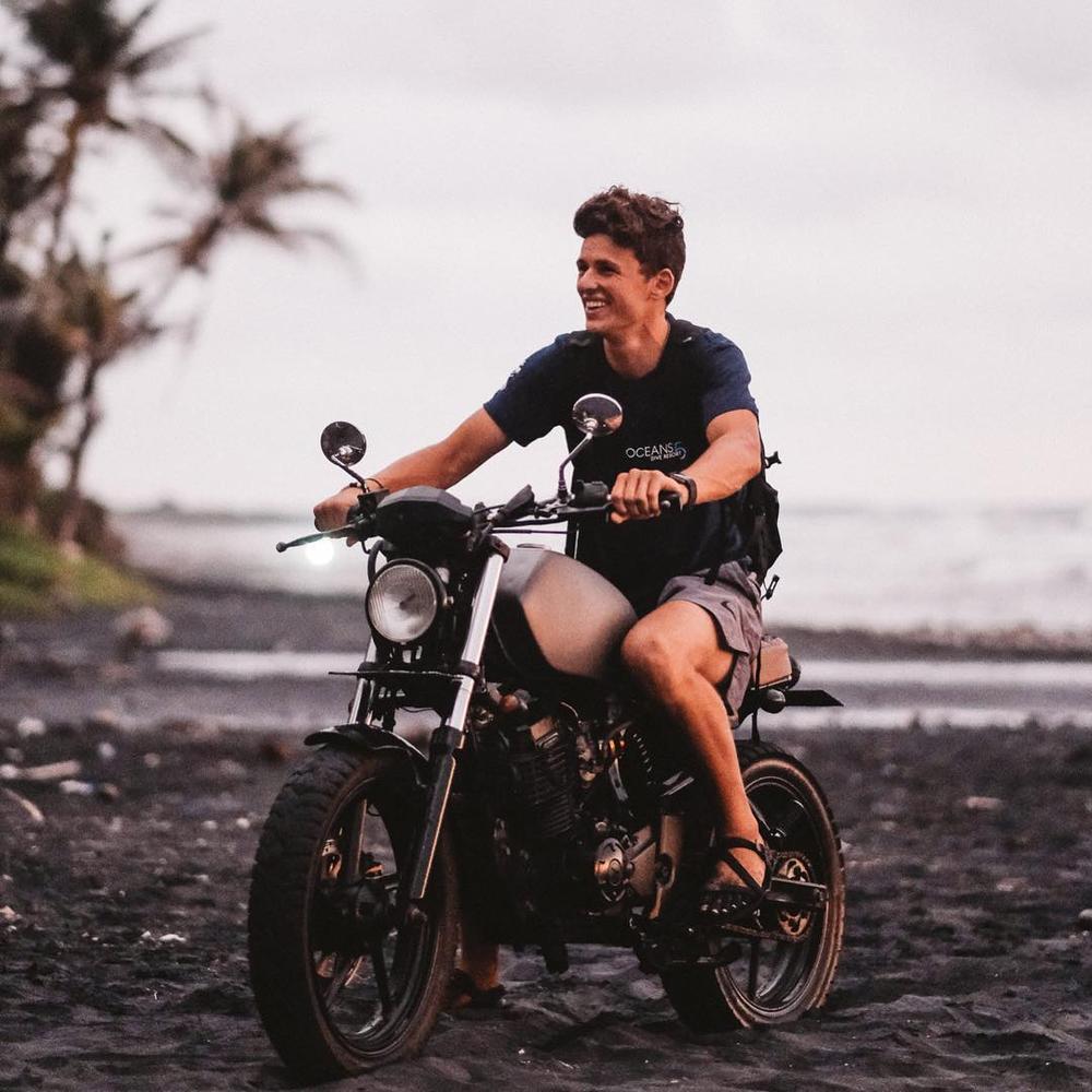 A man on a motorcycle wearing Xero Z-Treks Barefoot Sandals