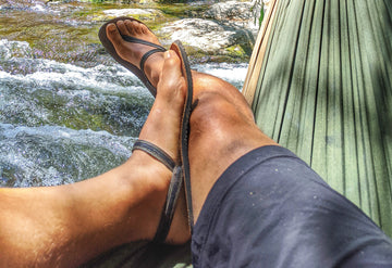 legs wearing Earthrunners Circadian barefoot sandals