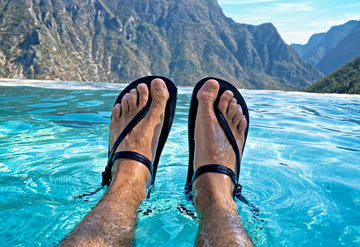 Legs wearing Elemental barefoot shoes in water