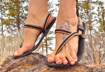 Legs wearing a pair pf barefoot shoes