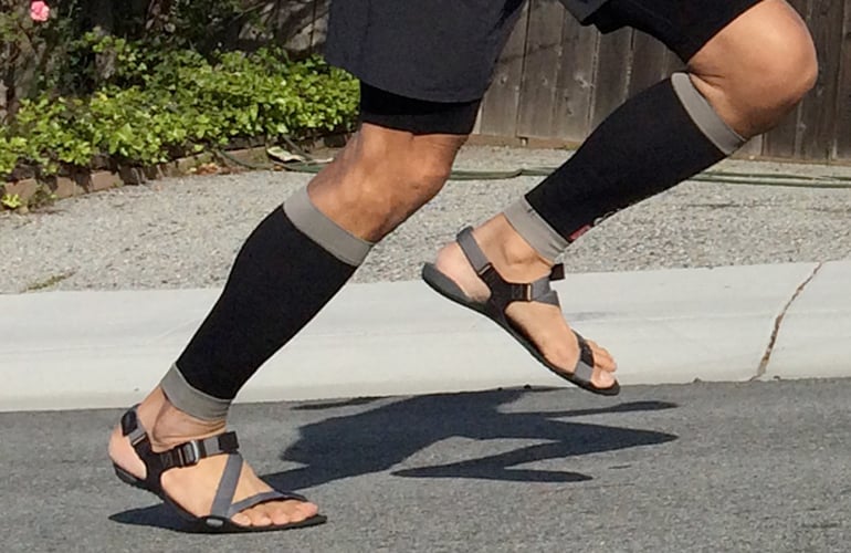 A man running with Xero Z-Treks barefoot sandals on