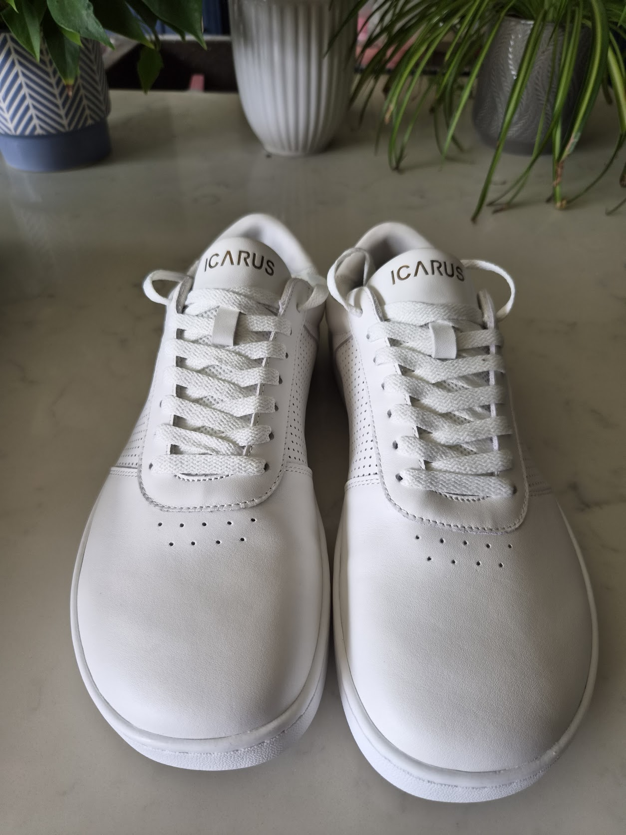 White/gold Ascent Gen 2 pair showing toe shape, leather, stitching and tongue lace loops