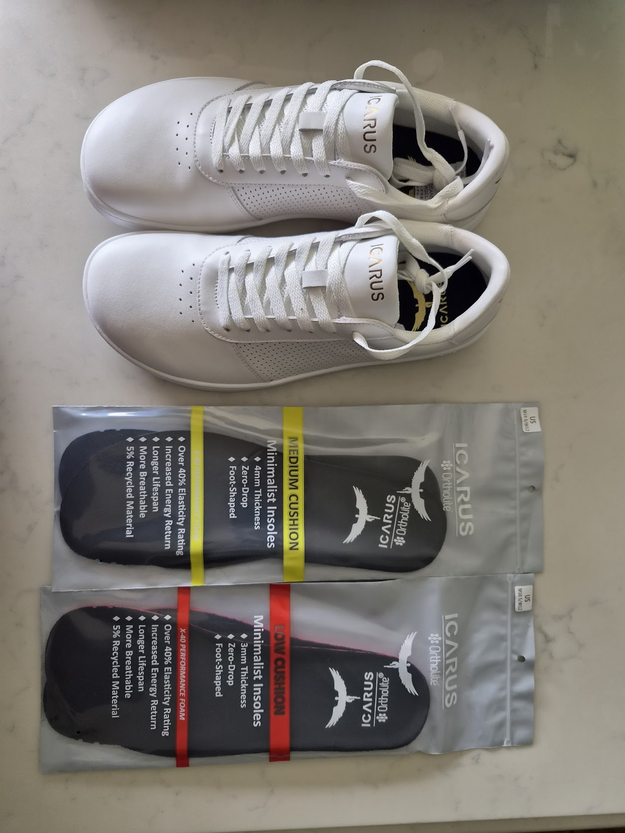 Adam’s white/gold pair beside packaged 3mm and 4mm insoles