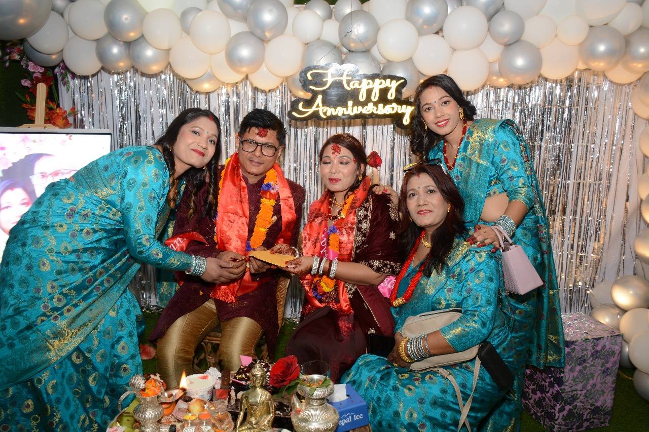 The couple receiving gifts from a guest.