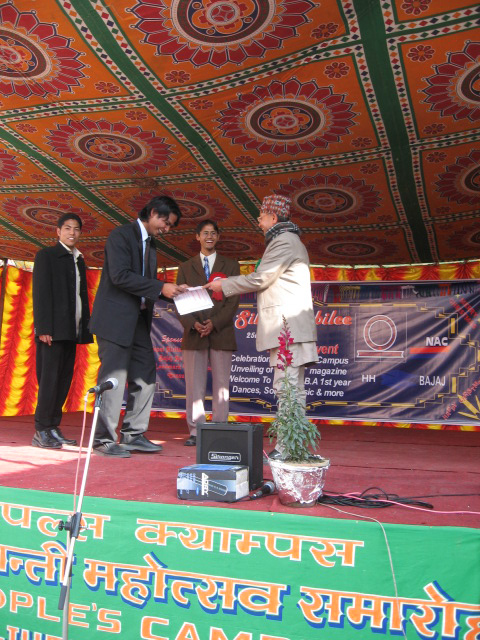 Rikesh Karna receiving a certificate of appreciation from the Campus Principal.