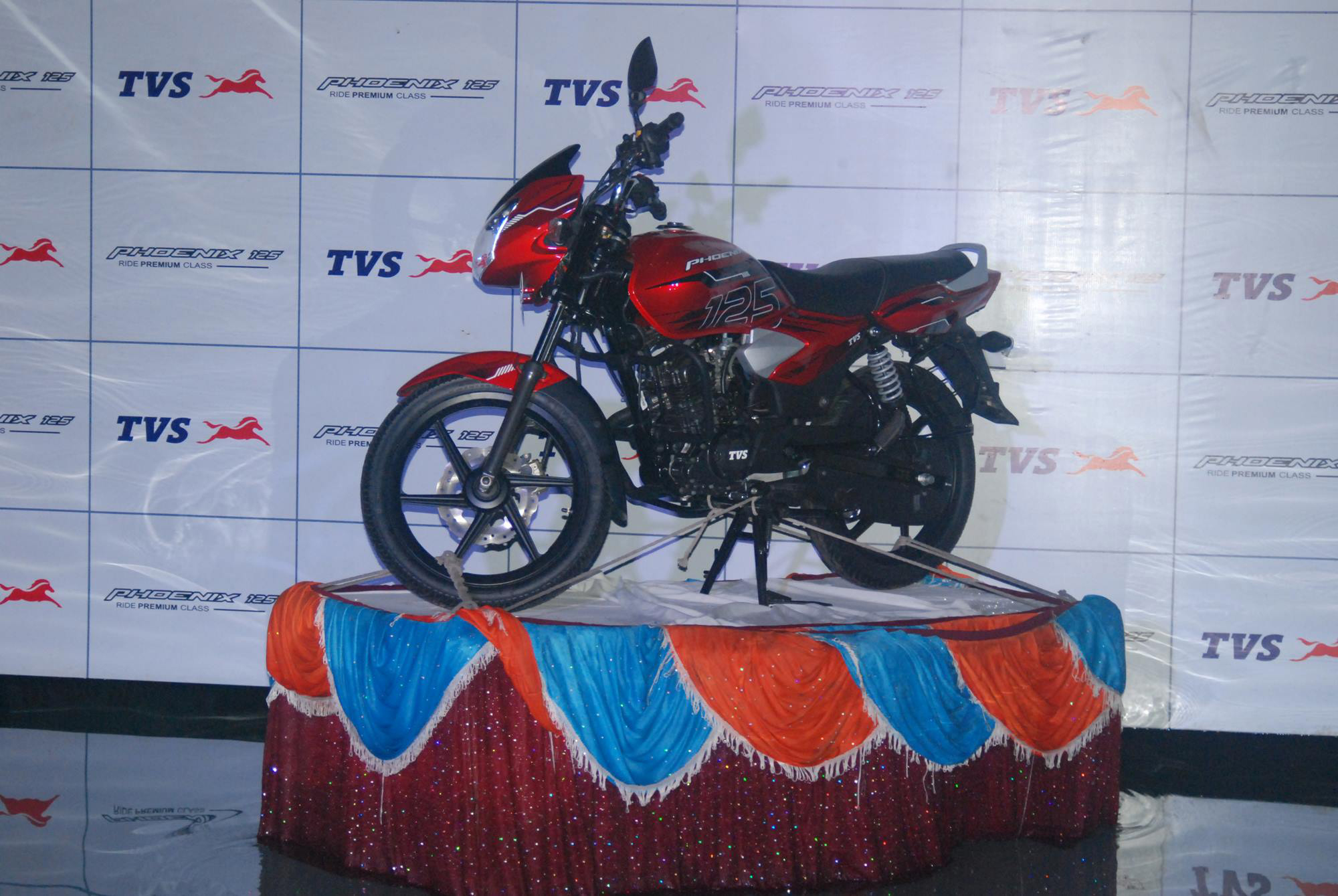A wide shot of the TVS Phoenix bike launch in the swimming pool.