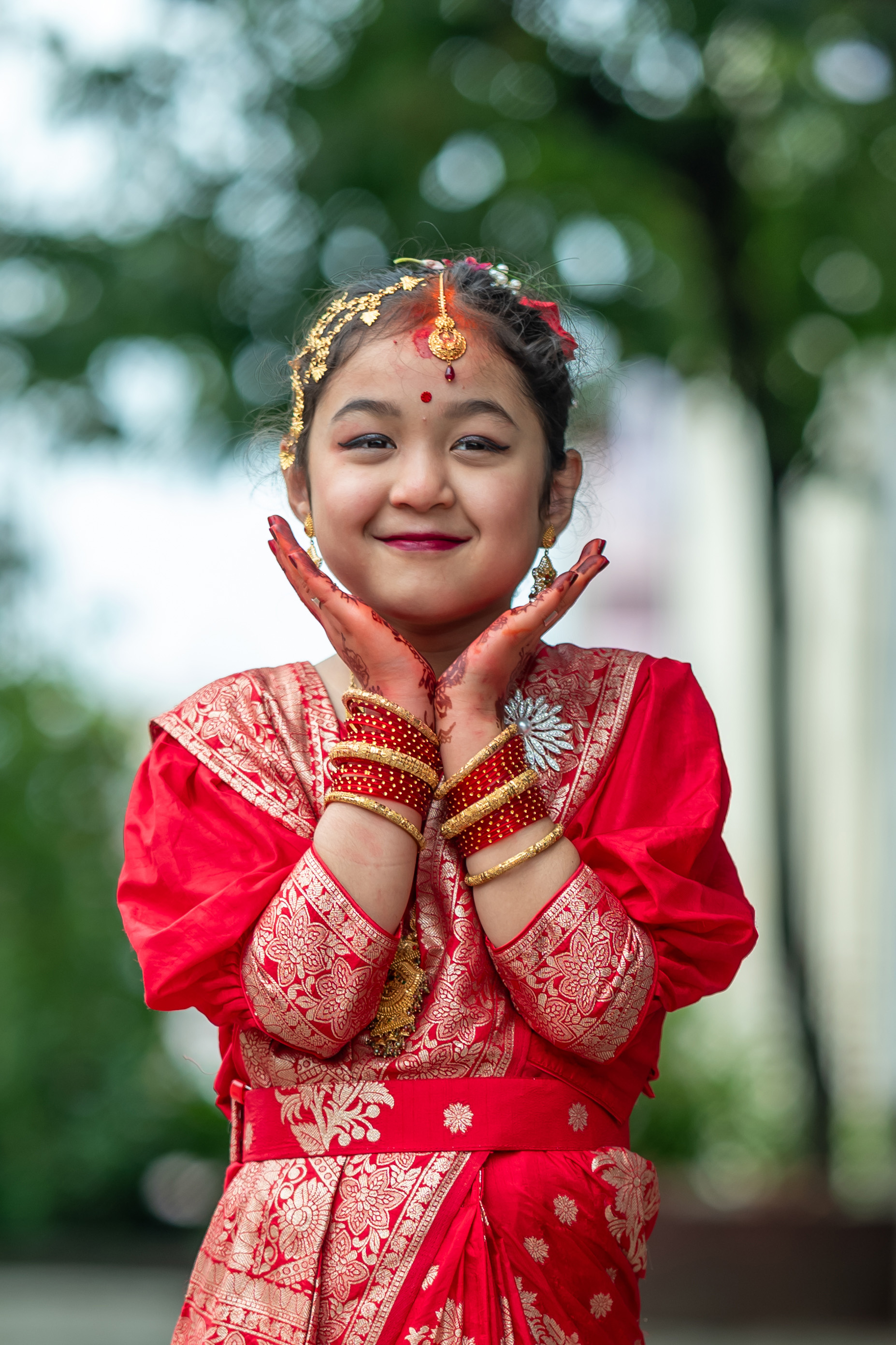 Bride posing for a photo at her Bel Bibaha ceremony.