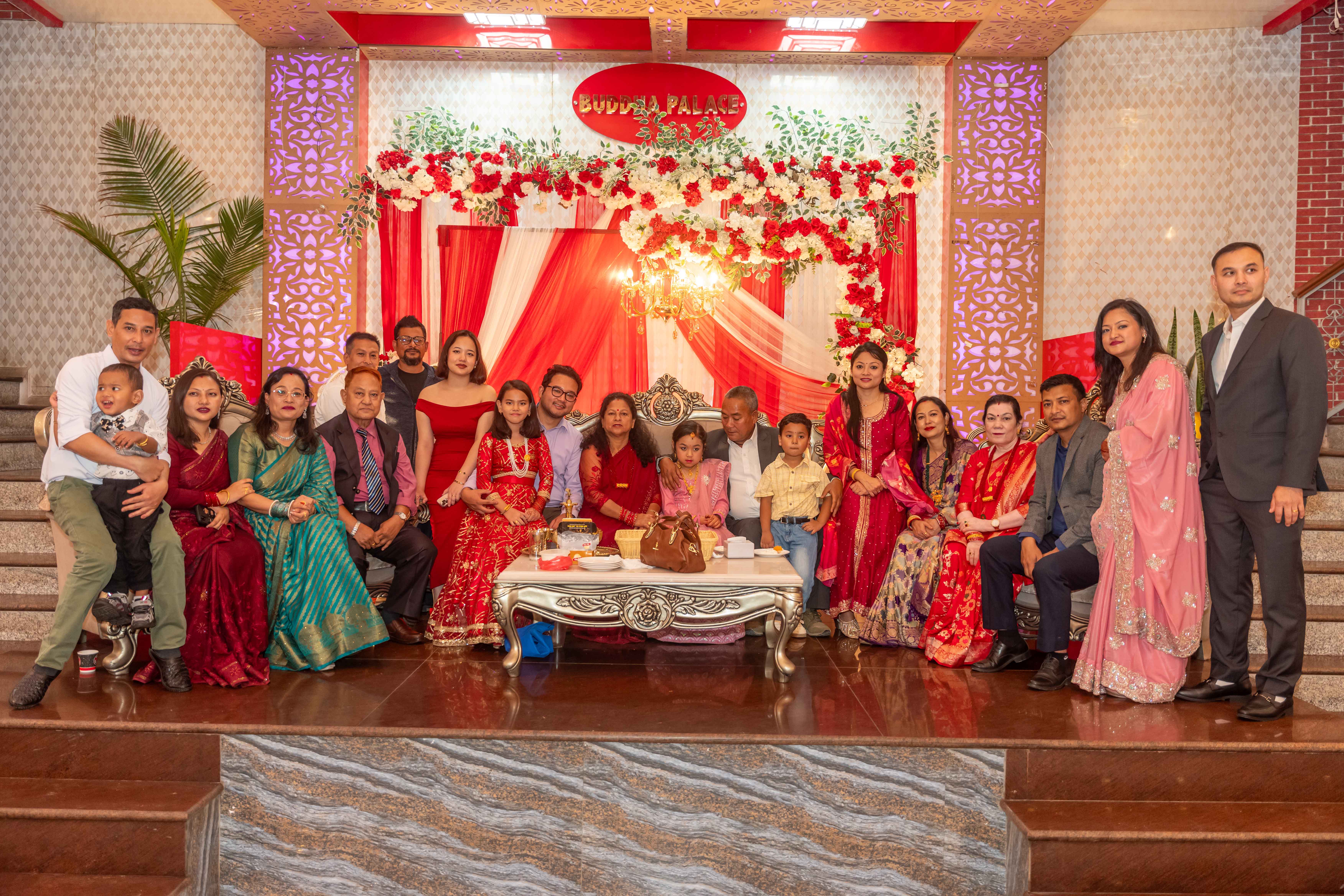 A guest posing for a photo with the bride on stage.