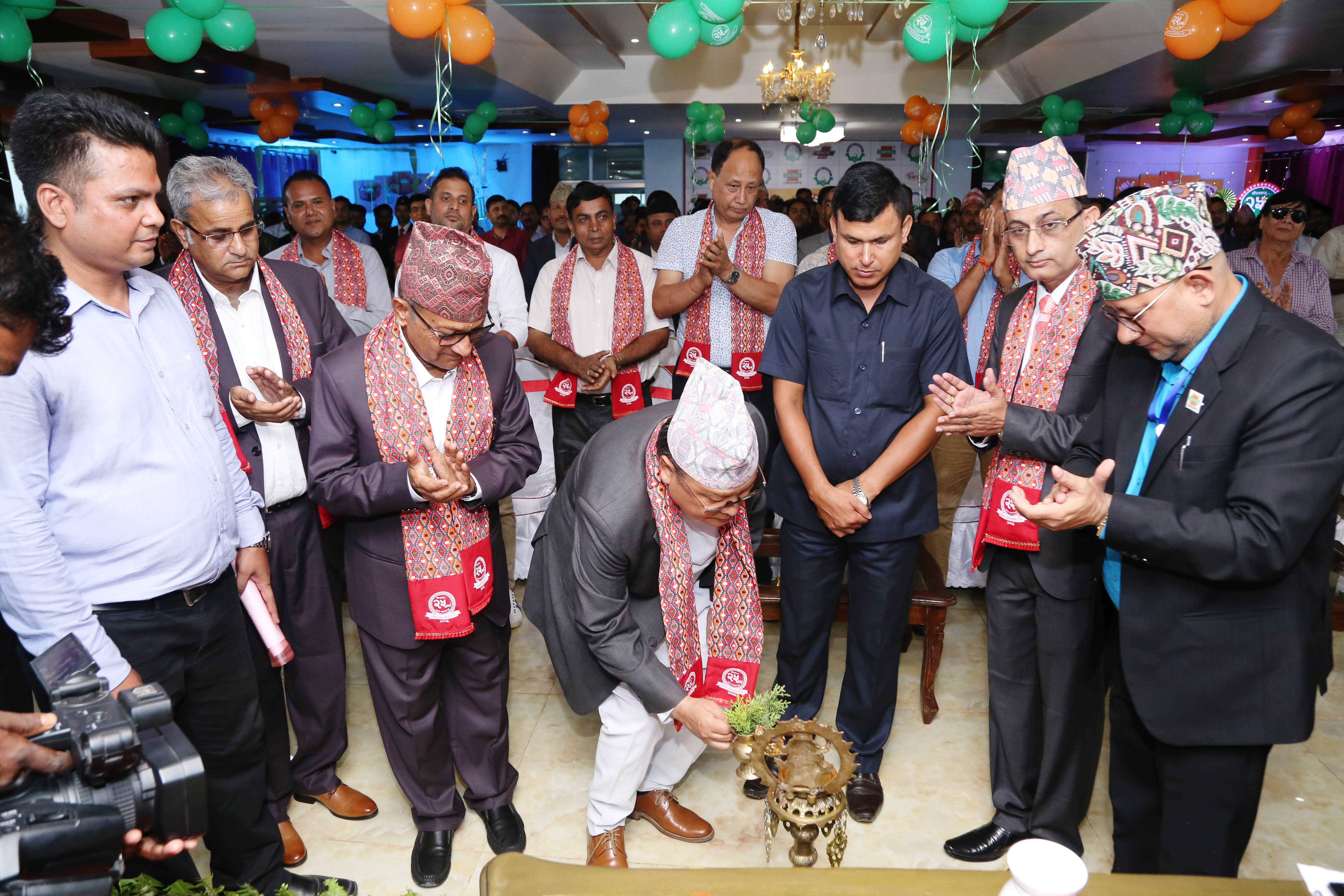 Chief Guest Dr. Govind Tumwong lighting panas with a company representative at the Fujima Group 25th Anniversary.