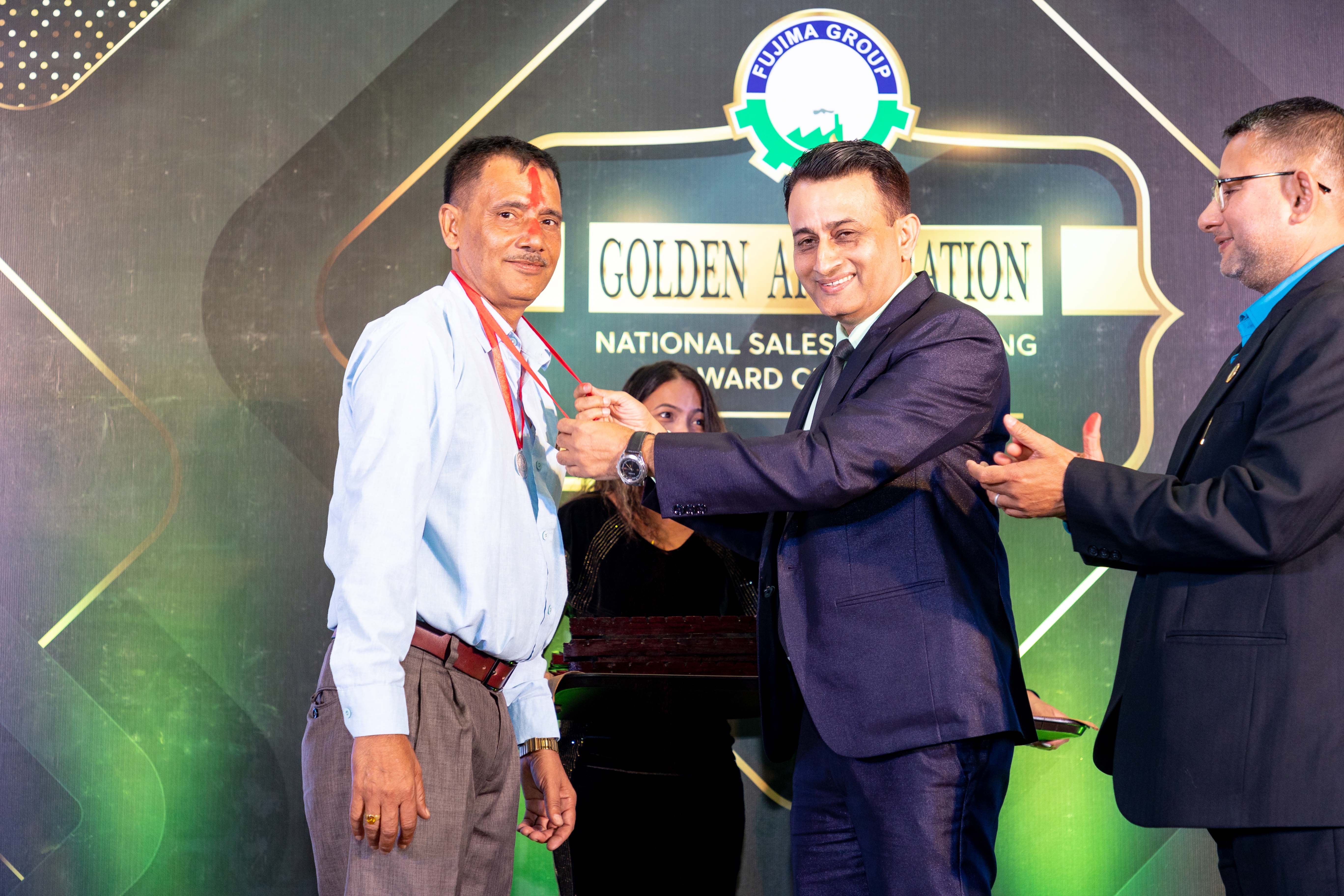 Managing Director Subodh Koirala presenting an award to the number one distributor.