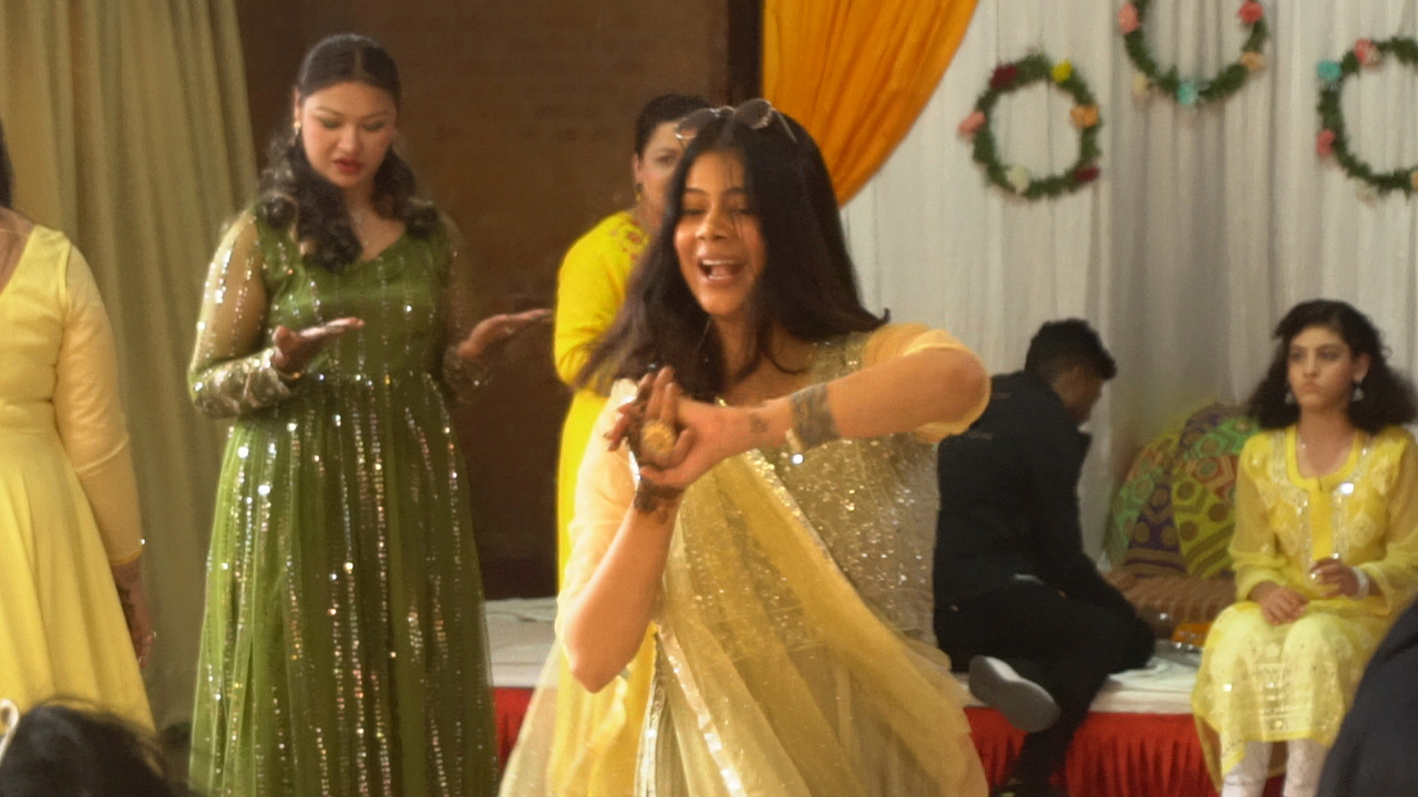 Family members dancing and celebrating at the Mehendi party.