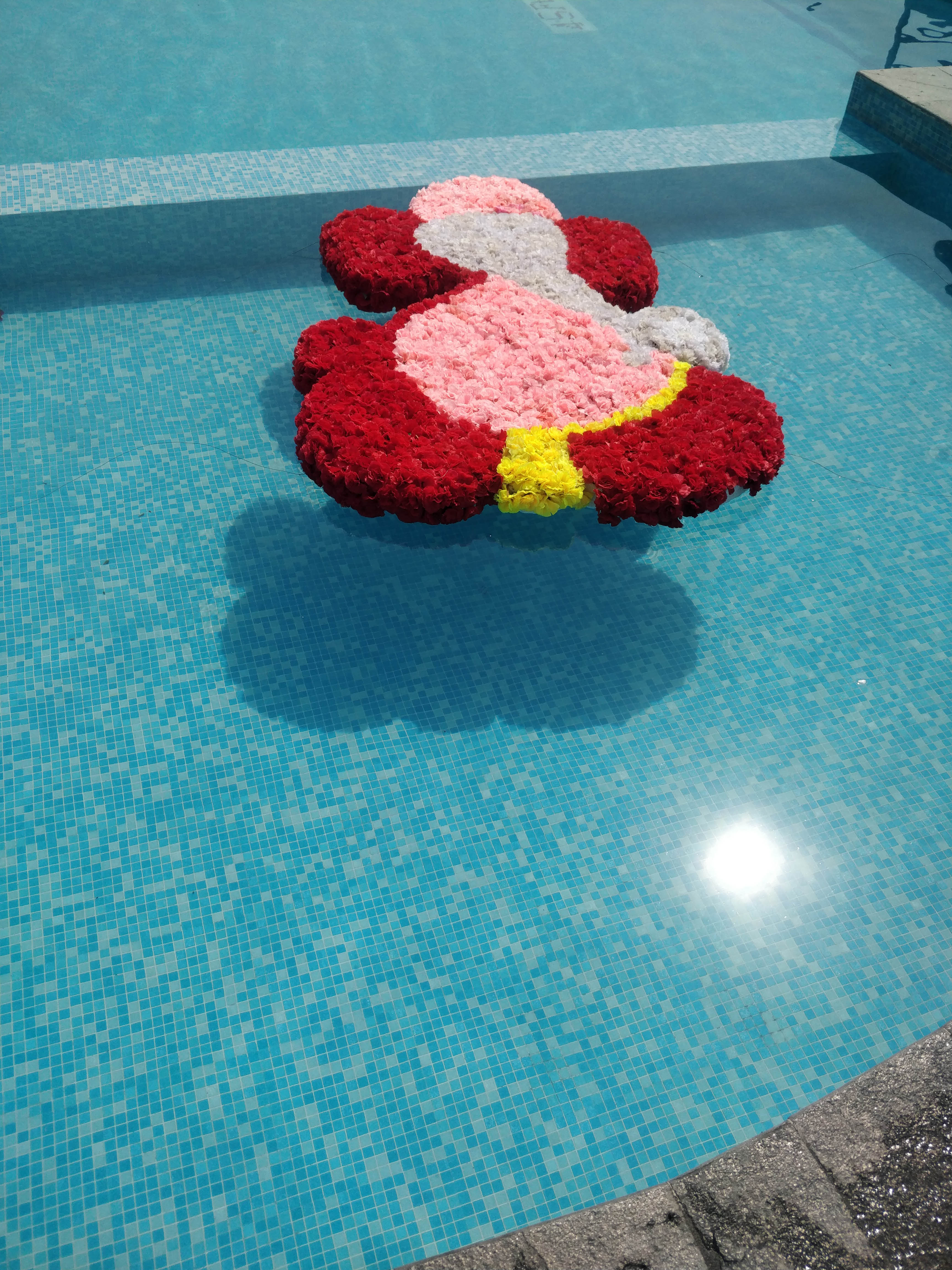 A floating Ganesh decoration in the resort swimming pool.