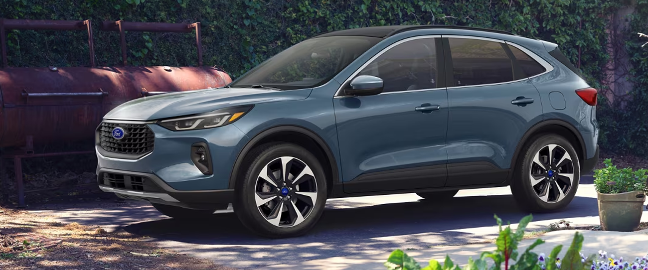 Vue 3/4 avant et latérale du Ford Escape PHEV en arrêt à une maison et bord de jardin