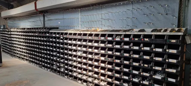 Lot of lin bins + contents + display shelves